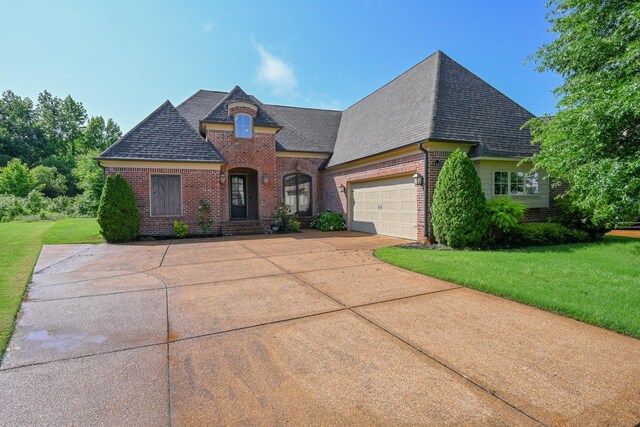 4342 Robinson Loop, Olive Branch, MS 38654 - french country inspired facade featuring brick siding, concrete driveway, and a front yard