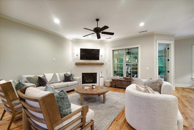 4342 Robinson Loop, Olive Branch, MS 38654 - living area featuring a ceiling fan, recessed lighting, ornamental molding, a large fireplace, and light wood-type flooring