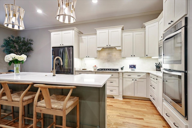 4342 Robinson Loop, Olive Branch, MS 38654 - kitchen with fridge with ice dispenser, double oven, ornamental molding, gas stovetop, and light countertops