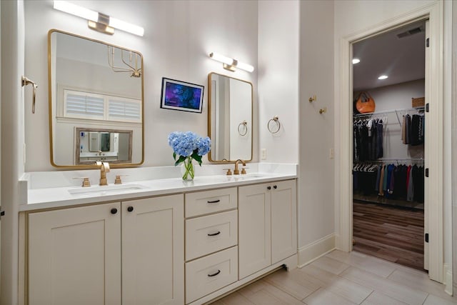 4342 Robinson Loop, Olive Branch, MS 38654 - bathroom featuring double vanity and a walk in closet