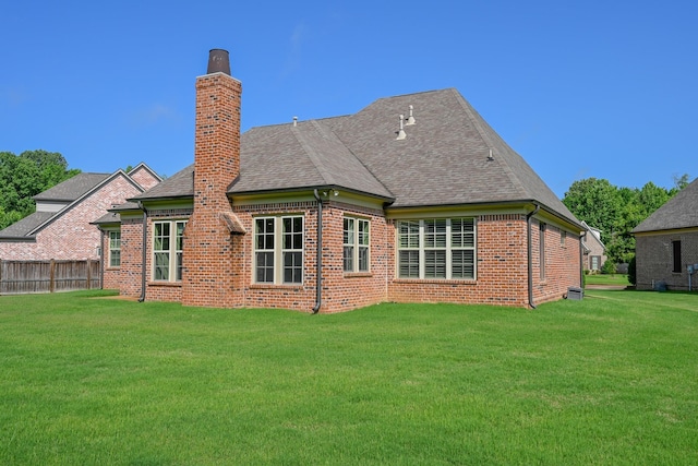 4342 Robinson Loop, Olive Branch, MS 38654 - back of house with brick siding, a chimney, and roof with shingles