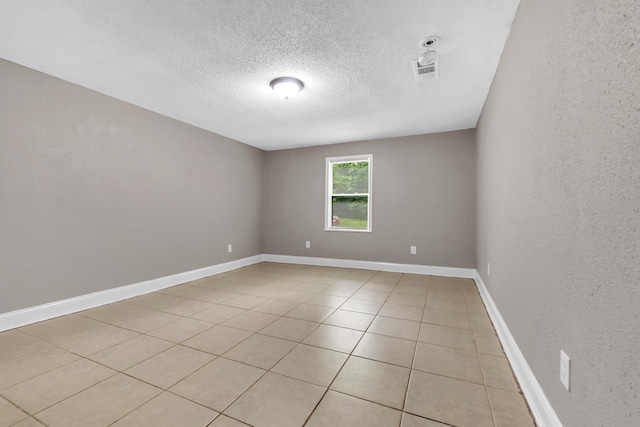 1017 Creston Ave, Memphis, TN 38127 - spare room featuring a textured ceiling and light tile patterned flooring