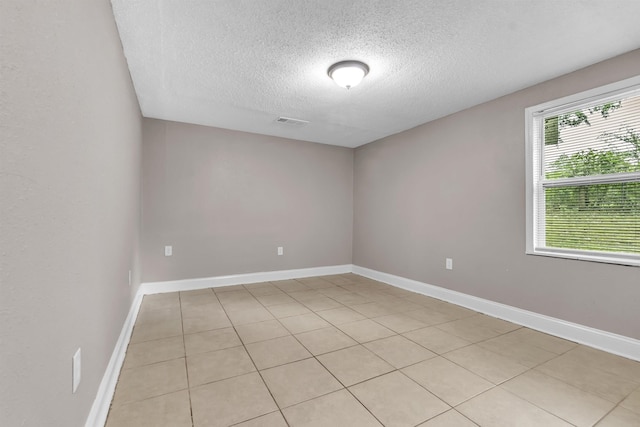 1017 Creston Ave, Memphis, TN 38127 - empty room with a textured ceiling and light tile patterned floors