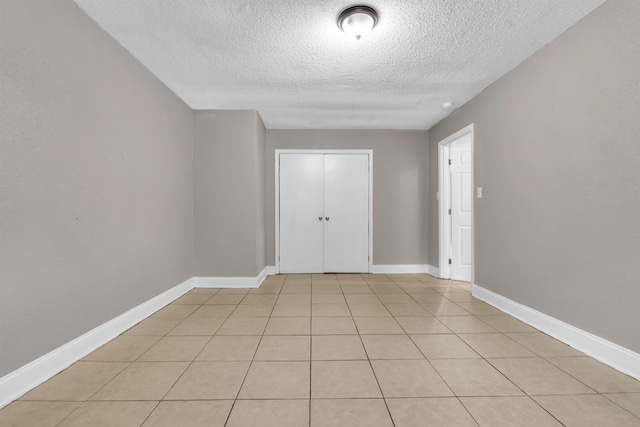 1017 Creston Ave, Memphis, TN 38127 - unfurnished room featuring a textured ceiling and light tile patterned flooring