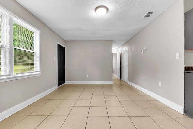 1017 Creston Ave, Memphis, TN 38127 - spare room with a textured ceiling and light tile patterned flooring