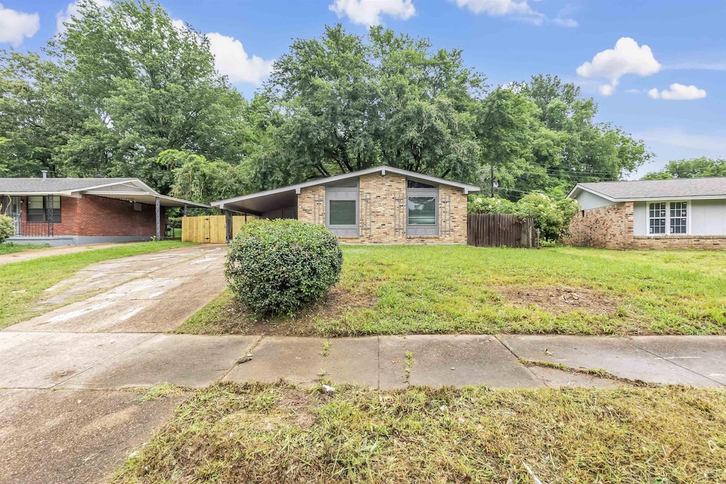 3526 Pueblo Ave, Memphis, TN 38127 - mid-century modern home with brick siding, a carport, and driveway