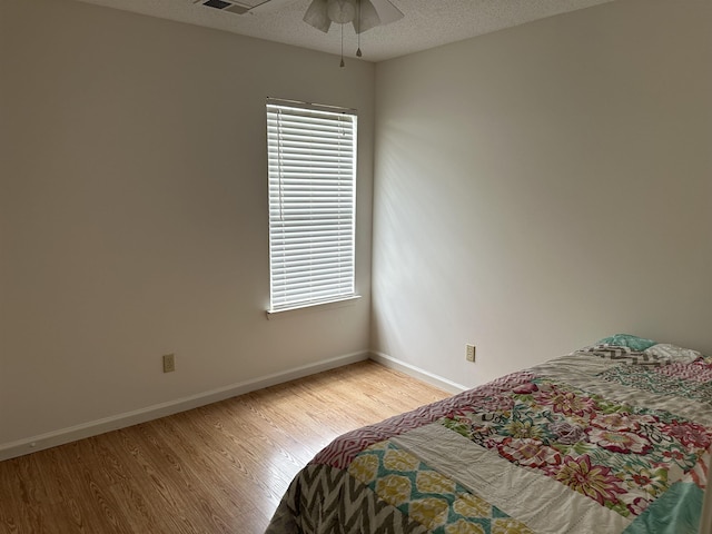 992 Zenith Cv N, Unicorp/Memphis, TN 38018 - bedroom with light wood-style flooring, a textured ceiling, multiple windows, and ceiling fan