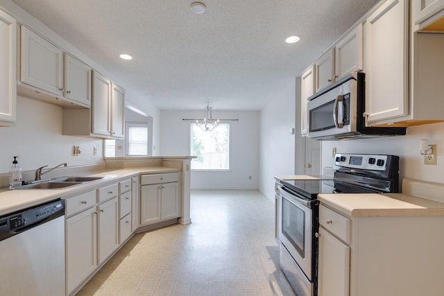 992 Zenith Cv N, Unicorp/Memphis, TN 38018 - kitchen featuring stainless steel appliances, recessed lighting, light countertops, light floors, and a chandelier