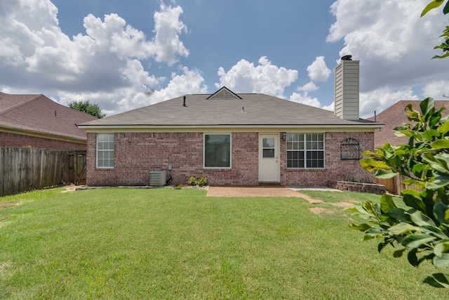 992 Zenith Cv N, Unicorp/Memphis, TN 38018 - rear view of property featuring a fenced backyard, brick siding, a chimney, and a patio