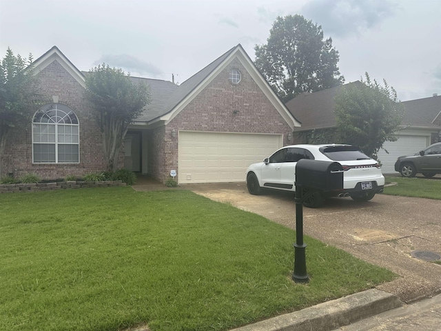 992 Zenith Cv N, Unicorp/Memphis, TN 38018 - view of front of home featuring brick siding, driveway, an attached garage, and a front yard