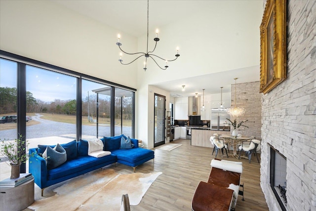 2270 Price Rd, Moscow, TN 38057 - living room with a chandelier, a towering ceiling, and light wood-style floors