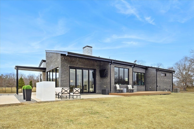 2270 Price Rd, Moscow, TN 38057 - rear view of property with a chimney, a yard, brick siding, and a patio area