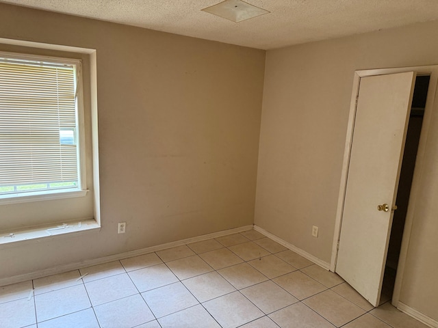 3612 Edgefield Dr, Memphis, TN 38128 - empty room with light tile patterned floors and a textured ceiling