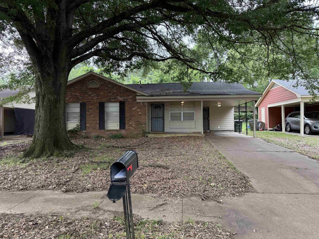 613 Burdette Ave, Memphis, TN 38127 - single story home with an attached carport, driveway, and brick siding