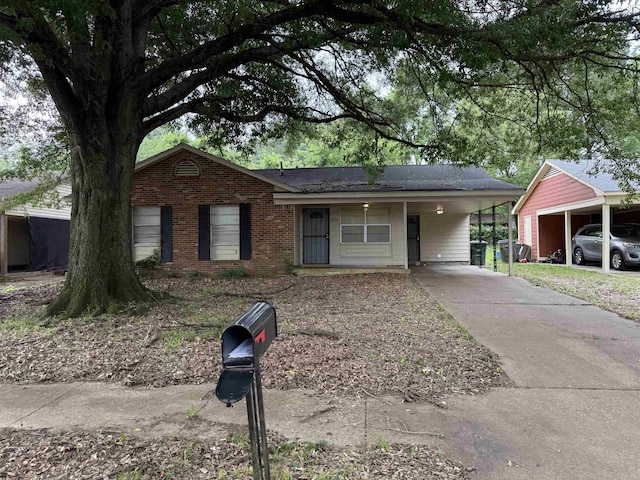 613 Burdette Ave, Memphis, TN 38127 - single story home with an attached carport, driveway, and brick siding