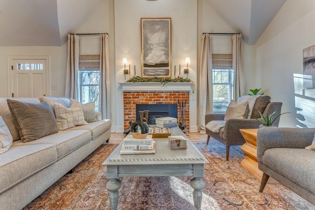 4950 Yum Yum Rd, Somerville, TN 38068 - living room featuring lofted ceiling, plenty of natural light, a brick fireplace, and wood finished floors