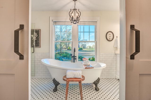4950 Yum Yum Rd, Somerville, TN 38068 - full bathroom featuring tile walls, wainscoting, tile patterned flooring, a chandelier, and a soaking tub