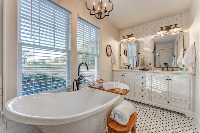 4950 Yum Yum Rd, Somerville, TN 38068 - bathroom with a chandelier, double vanity, a soaking tub, and tile walls