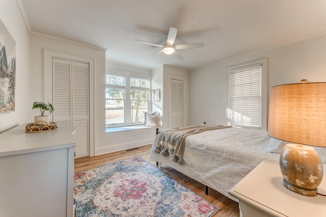 4950 Yum Yum Rd, Somerville, TN 38068 - bedroom with crown molding, two closets, wood finished floors, and ceiling fan