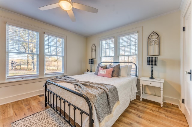 4950 Yum Yum Rd, Somerville, TN 38068 - bedroom with multiple windows, crown molding, light wood-type flooring, and a ceiling fan