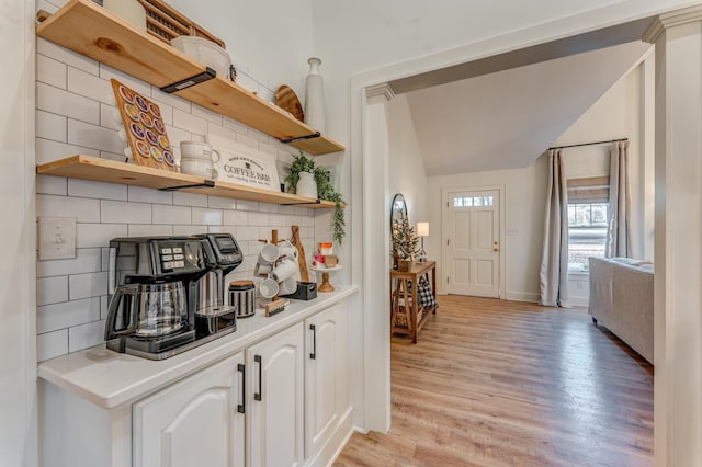 4950 Yum Yum Rd, Somerville, TN 38068 - bar with backsplash, light wood finished floors, and vaulted ceiling