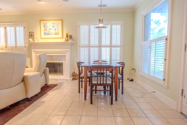 8799 Featherleigh Ln, Germantown, TN 38138 - dining space with ornamental molding, light tile patterned floors, healthy amount of natural light, and a high end fireplace