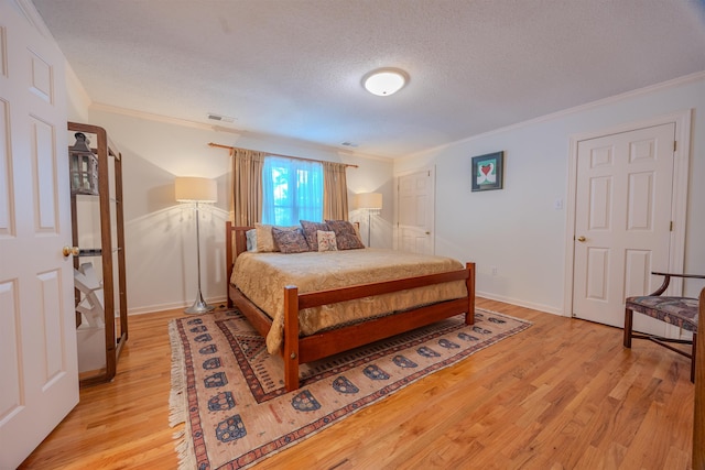 8799 Featherleigh Ln, Germantown, TN 38138 - bedroom with ornamental molding, light wood finished floors, and a textured ceiling