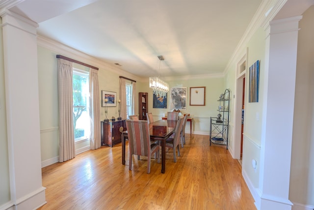 8799 Featherleigh Ln, Germantown, TN 38138 - dining room featuring a chandelier, light wood-style floors, ornate columns, and ornamental molding
