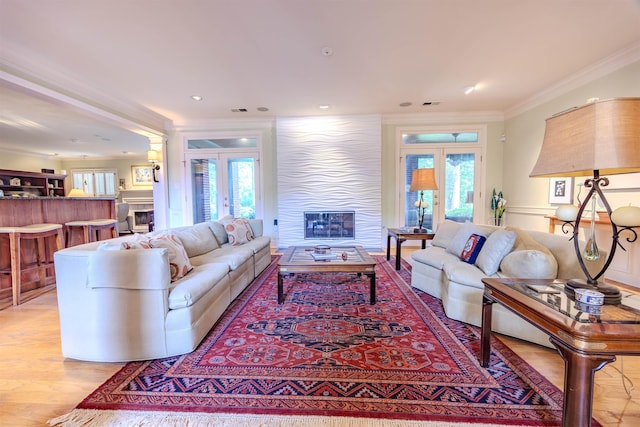 8799 Featherleigh Ln, Germantown, TN 38138 - living area featuring crown molding, french doors, healthy amount of natural light, light wood finished floors, and a glass covered fireplace