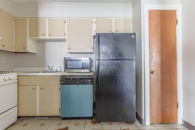 3229 Thirteen Colony Mall Unit 5B, Memphis, TN 38115 - kitchen with freestanding refrigerator, dishwashing machine, stainless steel microwave, gas range gas stove, and cream cabinetry