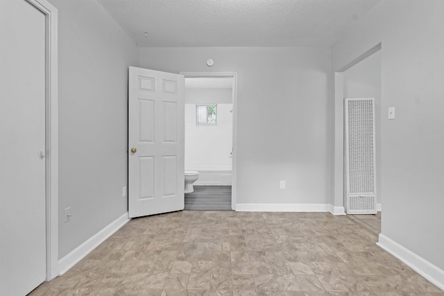 3205 E Shirley Cir, Memphis, TN 38127 - unfurnished bedroom with a heating unit, connected bathroom, and a textured ceiling