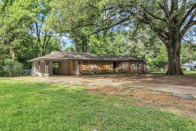 3205 E Shirley Cir, Memphis, TN 38127 - rear view of property with an attached carport, a yard, and dirt driveway
