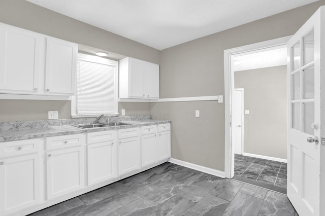 3257 Millington Rd, Memphis, TN 38127 - kitchen featuring white cabinetry and marble finish floors