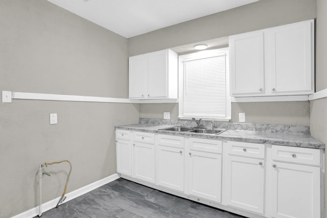 3257 Millington Rd, Memphis, TN 38127 - kitchen with marble look tiles, light countertops, and white cabinets