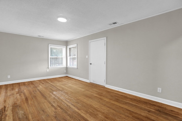 3257 Millington Rd, Memphis, TN 38127 - spare room featuring crown molding, wood finished floors, and a textured ceiling
