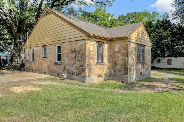 3257 Millington Rd, Memphis, TN 38127 - view of side of home featuring crawl space, roof with shingles, stone siding, and a yard