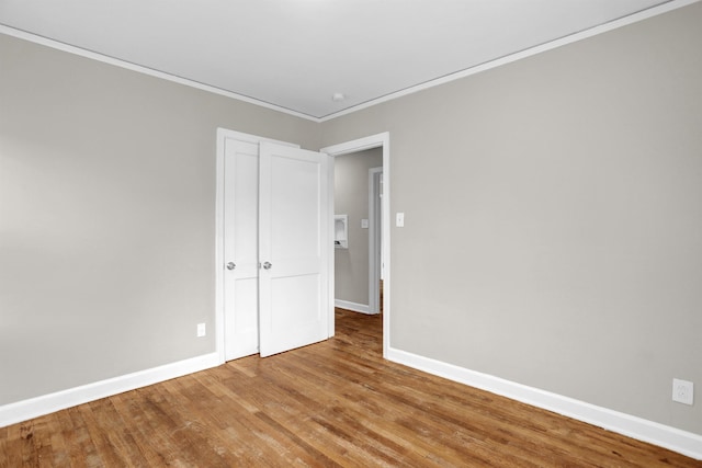 3257 Millington Rd, Memphis, TN 38127 - unfurnished bedroom with wood finished floors, crown molding, and a closet