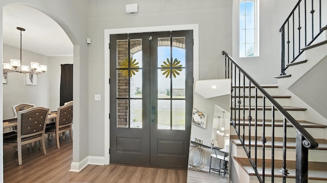 720 Woodland Fox Cv, Cordova, TN 38018 - entrance foyer featuring french doors, plenty of natural light, wood finished floors, and arched walkways
