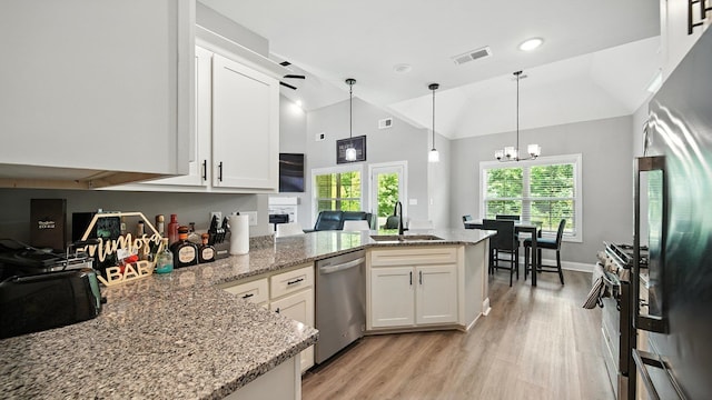 720 Woodland Fox Cv, Cordova, TN 38018 - kitchen with stainless steel appliances, a peninsula, light wood-style floors, white cabinets, and recessed lighting