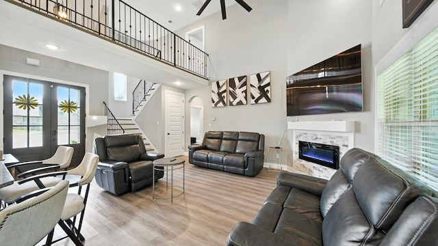 720 Woodland Fox Cv, Cordova, TN 38018 - living area featuring a high ceiling, arched walkways, light wood finished floors, stairs, and ceiling fan