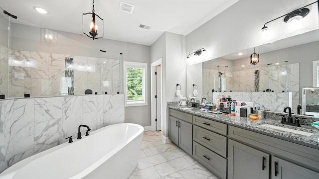 720 Woodland Fox Cv, Cordova, TN 38018 - bathroom featuring a freestanding bath, a marble finish shower, double vanity, marble finish flooring, and recessed lighting