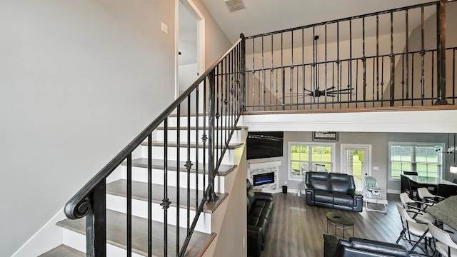 720 Woodland Fox Cv, Cordova, TN 38018 - staircase featuring a towering ceiling, wood finished floors, and a high end fireplace