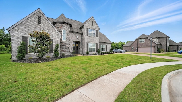 720 Woodland Fox Cv, Cordova, TN 38018 - french country inspired facade with a front yard, brick siding, and driveway