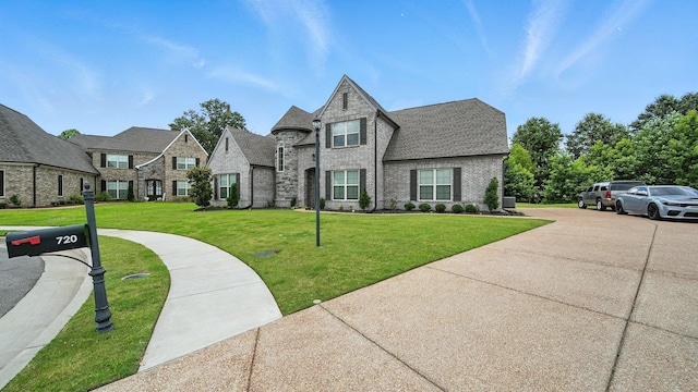 720 Woodland Fox Cv, Cordova, TN 38018 - french country home featuring a front lawn, brick siding, and roof with shingles
