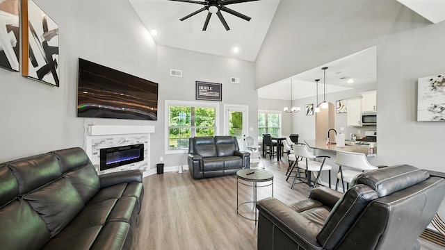 720 Woodland Fox Cv, Cordova, TN 38018 - living area with a ceiling fan, high vaulted ceiling, light wood-style floors, a glass covered fireplace, and recessed lighting