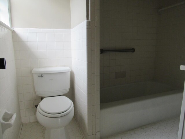 4632 Plato Ave, Memphis, TN 38128 - full bathroom with tile patterned flooring, wainscoting, tile walls, and shower / washtub combination