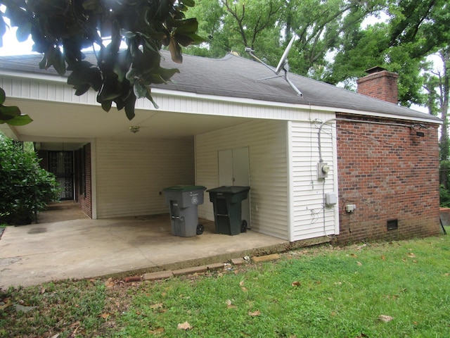 4632 Plato Ave, Memphis, TN 38128 - rear view of property with brick siding, a chimney, an attached carport, and roof with shingles