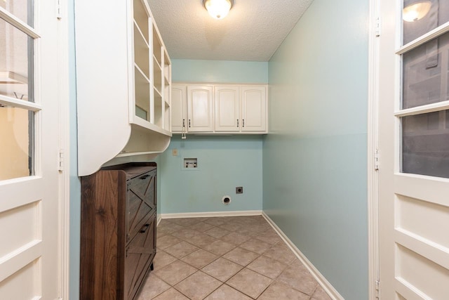 2539 Kenwood Rd, Bartlett, TN 38134 - washroom featuring washer hookup, electric dryer hookup, a textured ceiling, cabinet space, and light tile patterned floors