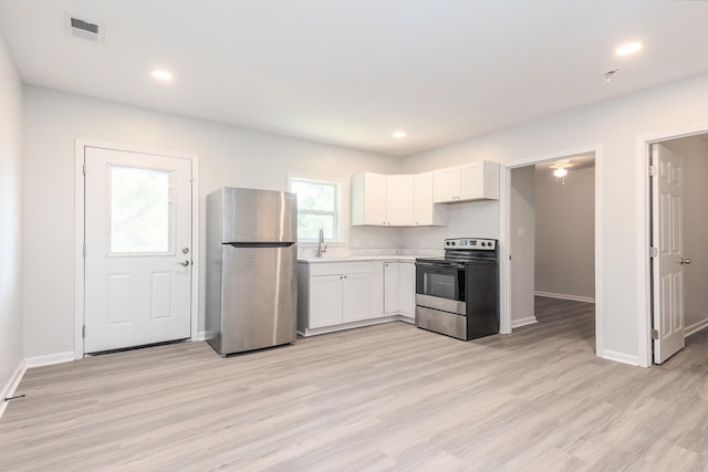 2539 Kenwood Rd, Bartlett, TN 38134 - kitchen with stainless steel appliances, light countertops, white cabinets, light wood finished floors, and recessed lighting