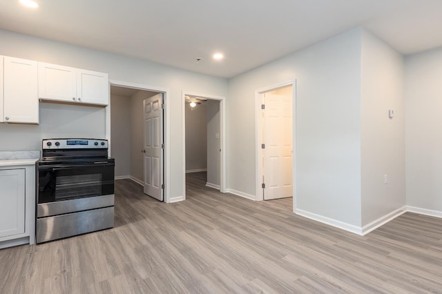 2539 Kenwood Rd, Bartlett, TN 38134 - kitchen featuring stainless steel electric range oven, light wood finished floors, recessed lighting, light countertops, and white cabinets